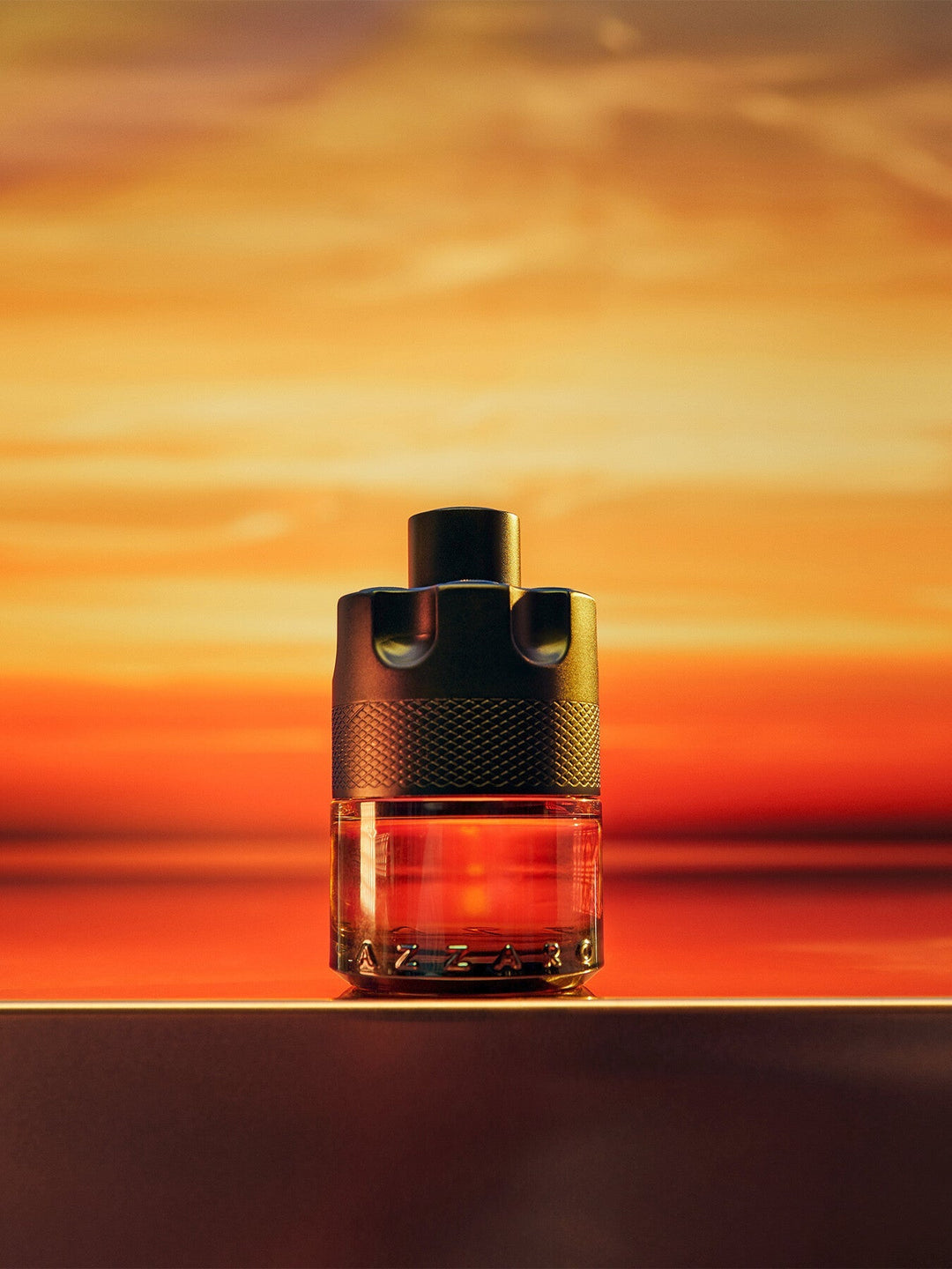 Azzaro The Most Wanted Parfum 100mL bottle at sunset
